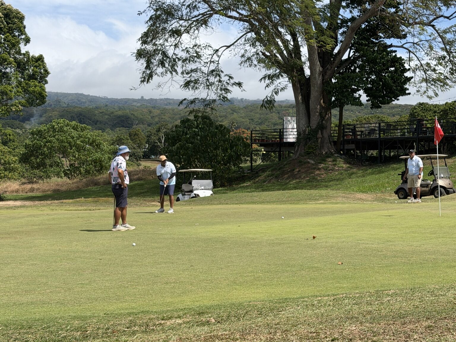 Golfers competing on a putting green at Faleata Golf Course