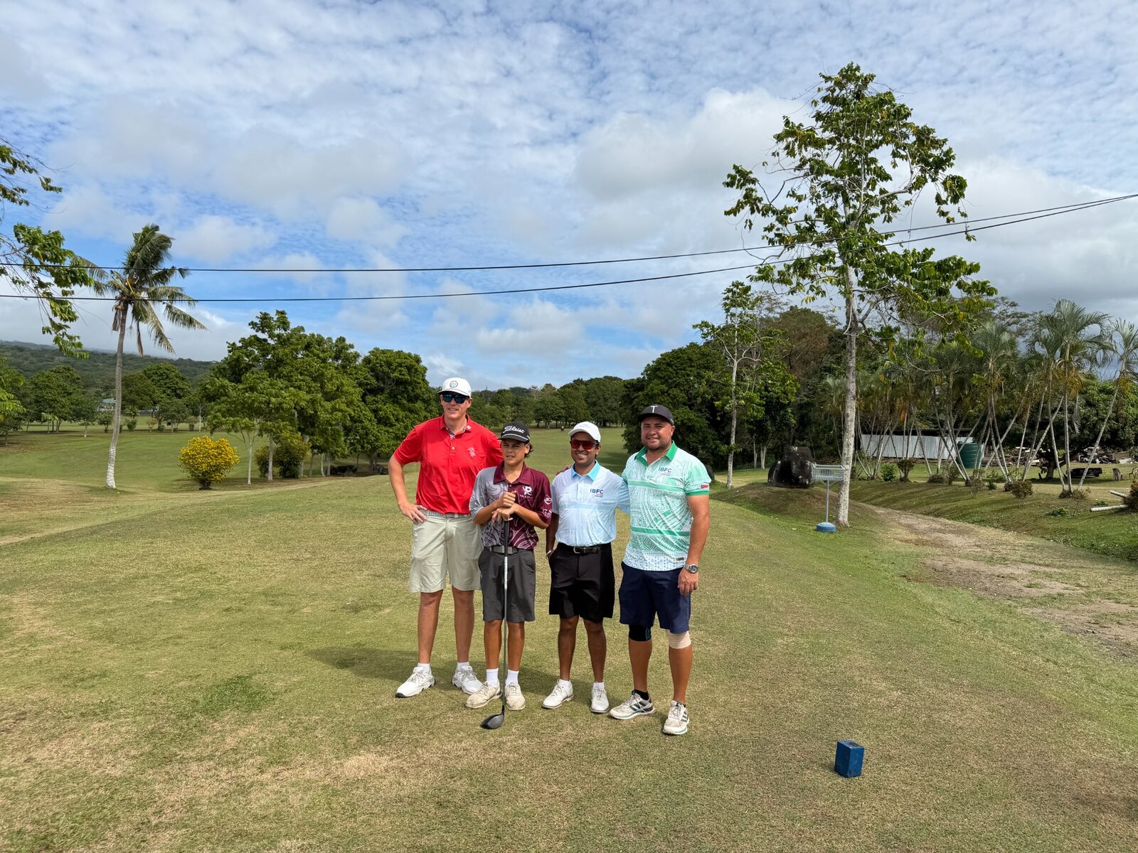 A group of competitors gathered at a tee during the Samoa Open