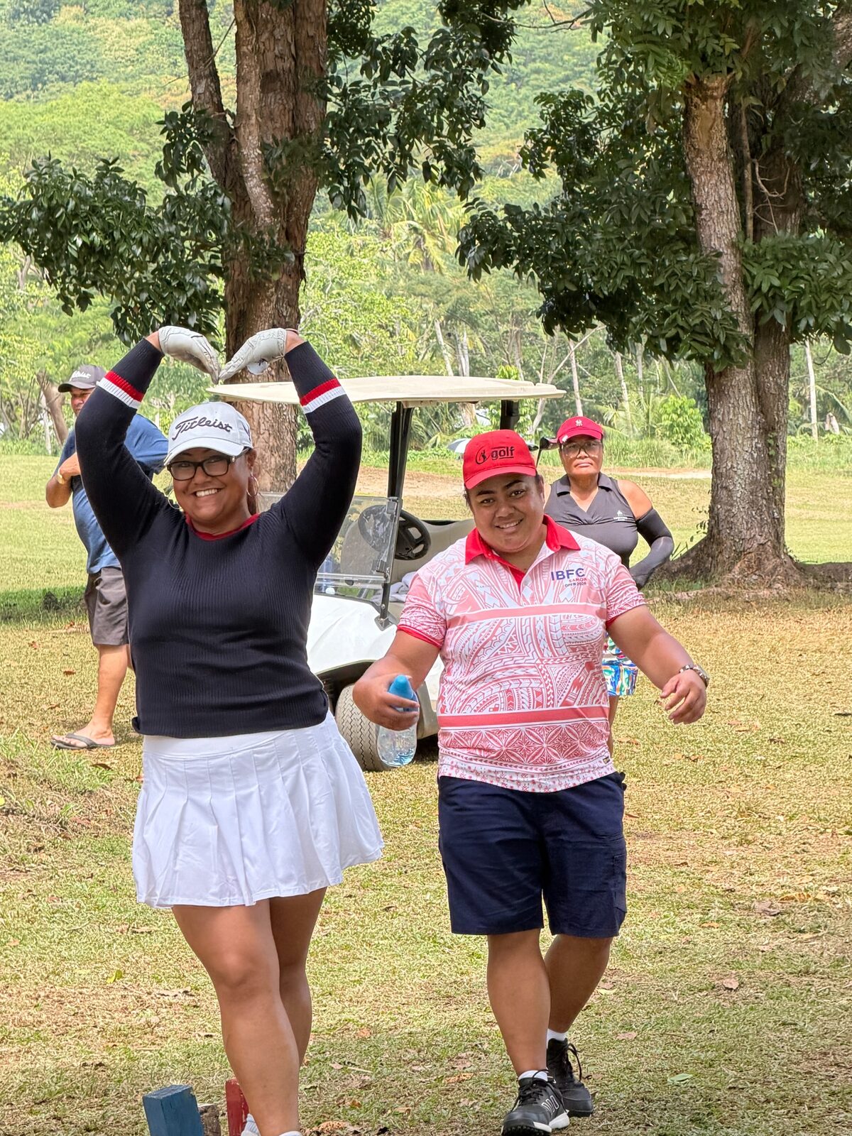 Women golfers celebrating together during the Samoa Open