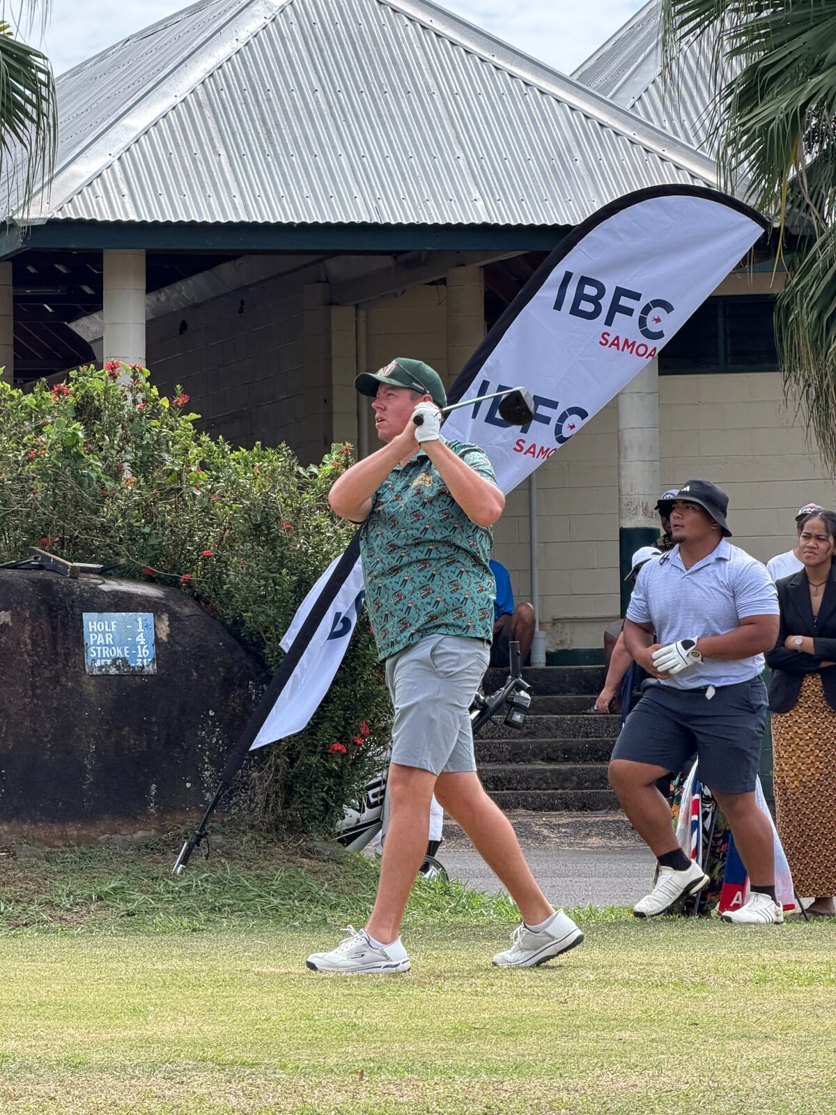 A woman golfer following through after a tee shot