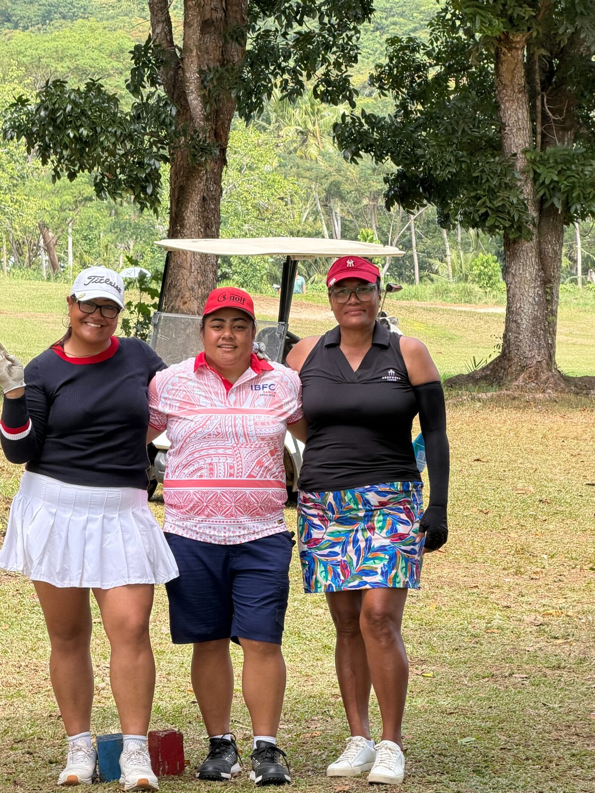 Three women golfers standing together during the Samoa Open
